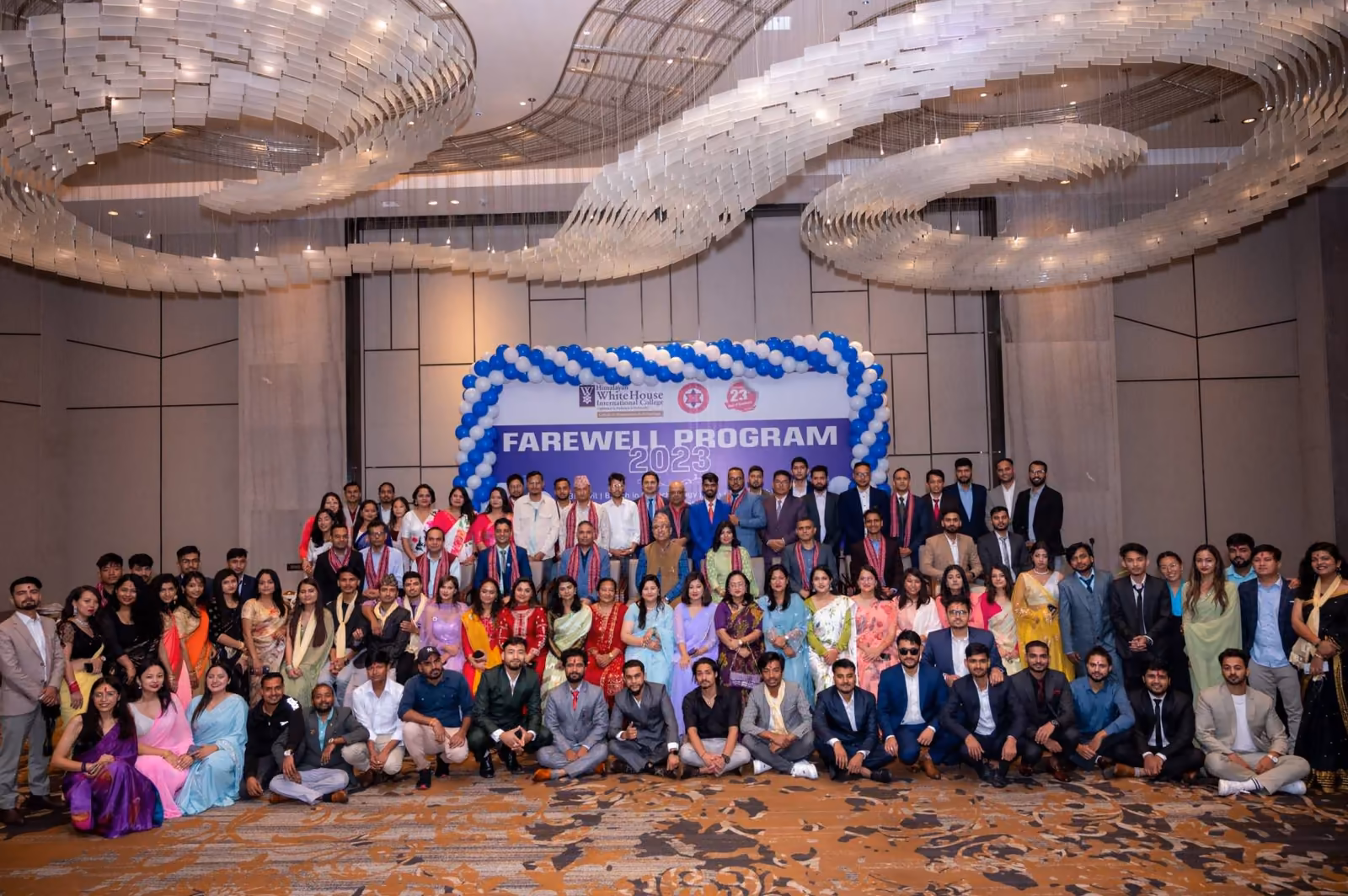A farewell programme photographed under a banquet hall's curved ceiling, the whole group together