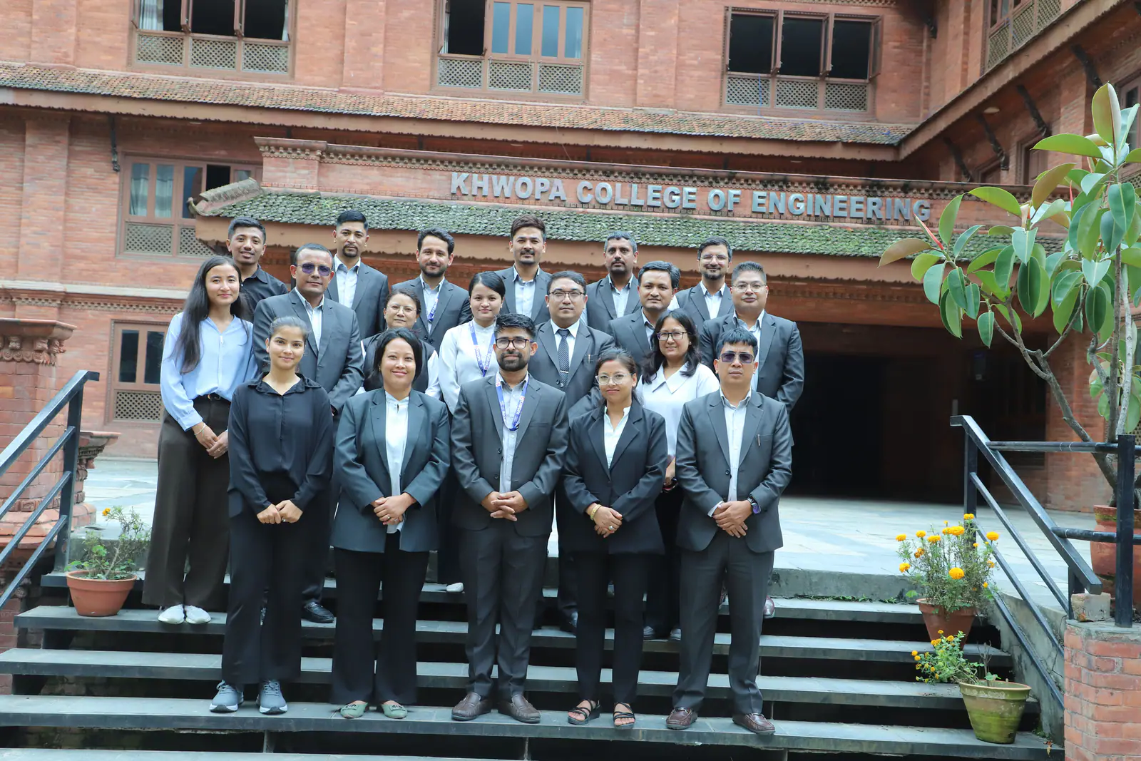 Students on the steps under the Khwopa College of Engineering signboard