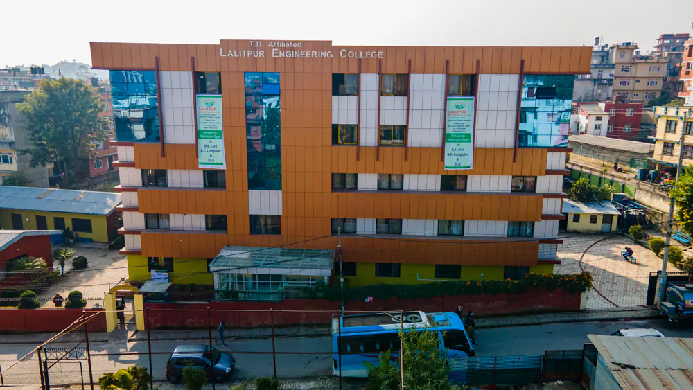 The college block from the air, its name along the parapet and the valley behind
