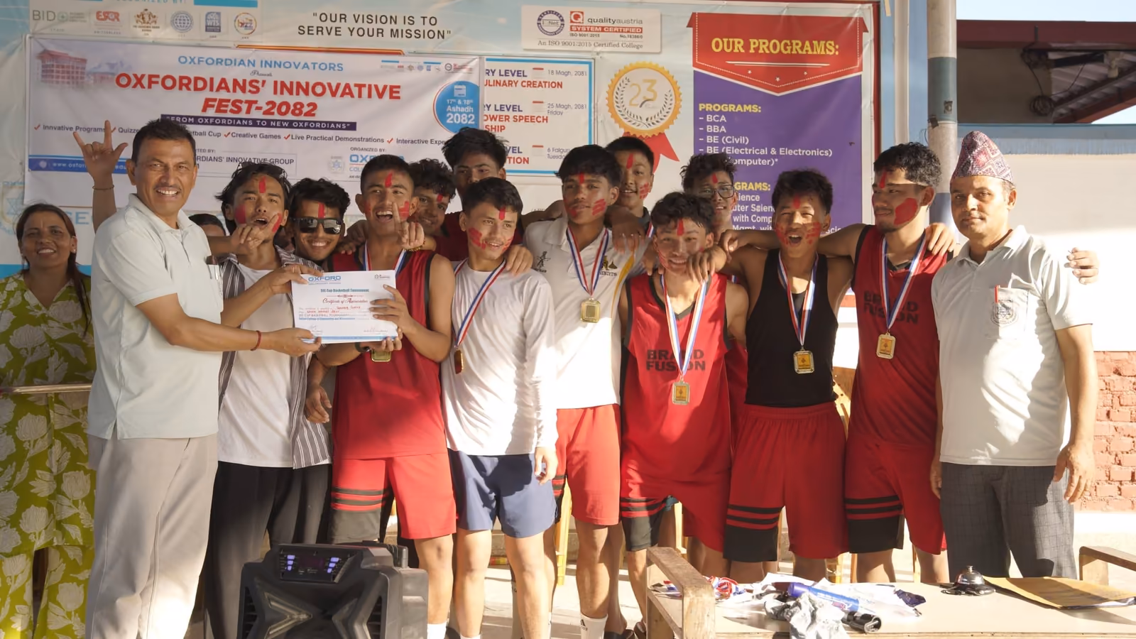 A team in kit holding their medals and a certificate after the college sports week